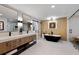 Bright bathroom with double sink vanity, soaking tub, and glass-enclosed shower at 6124 Kings Mountain Ct, Stone Mountain, GA 30087