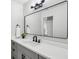 Bathroom featuring gray cabinets, a large mirror, and a white countertop at 6124 Kings Mountain Ct, Stone Mountain, GA 30087