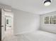 Bedroom featuring an open doorway to another room and large windows at 6124 Kings Mountain Ct, Stone Mountain, GA 30087
