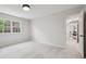 Spacious bedroom with natural light and soft carpet, with a view into the next room at 6124 Kings Mountain Ct, Stone Mountain, GA 30087