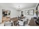 An elegant dining room features a modern chandelier and stylish decor with seating for six at 6124 Kings Mountain Ct, Stone Mountain, GA 30087