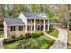 Well-manicured lawn and driveway enhance this beautiful brick home with striking black shutters and inviting front porch at 6124 Kings Mountain Ct, Stone Mountain, GA 30087