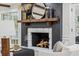 Close up of fireplace mantle with mirror and vases flanked by seating at 6124 Kings Mountain Ct, Stone Mountain, GA 30087
