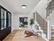 Bright foyer featuring hardwood floors, staircase, and stylish bench welcomes you into this beautifully designed home at 6124 Kings Mountain Ct, Stone Mountain, GA 30087