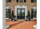 Charming front porch with double doors, decorative lanterns, and potted greenery, exudes a warm and inviting atmosphere at 6124 Kings Mountain Ct, Stone Mountain, GA 30087
