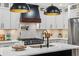 Bright kitchen with large island, pendant lighting, and stainless steel appliances with marble backsplash at 6124 Kings Mountain Ct, Stone Mountain, GA 30087
