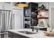 Kitchen island with stainless steel sink and high-end faucet, plus stainless steel appliances and a beverage cooler at 6124 Kings Mountain Ct, Stone Mountain, GA 30087