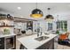 Open kitchen features large island with seating and stainless steel sink, adjacent to dining area and living room at 6124 Kings Mountain Ct, Stone Mountain, GA 30087