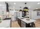 Modern eat-in kitchen with stainless steel appliances and fixtures, large island, and white cabinets at 6124 Kings Mountain Ct, Stone Mountain, GA 30087