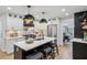 Open concept kitchen with white cabinetry, kitchen island and breakfast bar plus dining area at 6124 Kings Mountain Ct, Stone Mountain, GA 30087