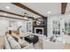 Bright living room with wood beam ceilings, a brick fireplace, and ample seating at 6124 Kings Mountain Ct, Stone Mountain, GA 30087