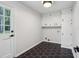 Mud room with tile floors, ample cabinet space, and convenient exterior access at 6124 Kings Mountain Ct, Stone Mountain, GA 30087