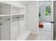 Walk-in closet with built-in shelving and view of a bedroom seating area at 6124 Kings Mountain Ct, Stone Mountain, GA 30087