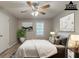 A staged bedroom featuring a ceiling fan, modern decor, and a white comforter at 104 Natchez Trce, Atlanta, GA 30350
