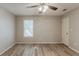 Bedroom showcasing natural light from a window, wood-look flooring, and ceiling fan at 104 Natchez Trce, Atlanta, GA 30350