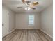 A bright, empty bedroom features a ceiling fan and modern flooring at 104 Natchez Trce, Atlanta, GA 30350