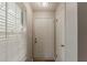 Entryway with a white front door, blinds on the window, and a neutral color scheme at 104 Natchez Trce, Atlanta, GA 30350