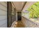 Charming front porch with wooden flooring, black door, and wooden lattice fencing at 104 Natchez Trce, Atlanta, GA 30350