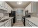 Well-equipped kitchen featuring stainless steel appliances, ample counter space, and pantry at 104 Natchez Trce, Atlanta, GA 30350