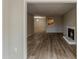 Spacious living room with fireplace and a view to the kitchen with hardwood floors at 104 Natchez Trce, Atlanta, GA 30350