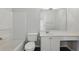 Bright bathroom featuring a tub, toilet, vanity with sink and a large mirror above the sink at 10900 Wittenridge Dr # D5, Alpharetta, GA 30022