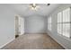 Bedroom featuring neutral carpet and a partial view of an attached bathroom at 10900 Wittenridge Dr # D5, Alpharetta, GA 30022