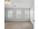 Bedroom with natural light from three windows and white shutters at 10900 Wittenridge Dr # D5, Alpharetta, GA 30022