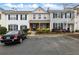 Traditional townhome showcasing a well-kept front yard, a driveway and black shutters at 10900 Wittenridge Dr # D5, Alpharetta, GA 30022