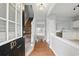 Inviting foyer with hardwood floors, staircase, and views of the kitchen and living area at 10900 Wittenridge Dr # D5, Alpharetta, GA 30022