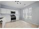 Bright kitchen featuring white cabinets, stainless steel appliances, and tile flooring at 10900 Wittenridge Dr # D5, Alpharetta, GA 30022