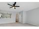 Neutral living room featuring a ceiling fan and an open view into the kitchen at 10900 Wittenridge Dr # D5, Alpharetta, GA 30022