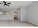Bright living room featuring a ceiling fan and view into the kitchen at 10900 Wittenridge Dr # D5, Alpharetta, GA 30022