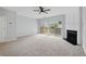 Cozy living room with plush carpeting, fireplace, and sliding doors to the backyard at 10900 Wittenridge Dr # D5, Alpharetta, GA 30022