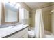 Bathroom with a granite countertop vanity, mirror, and a shower-tub combination with tile surround at 1207 Mcclelen Way, Decatur, GA 30033
