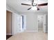 Bedroom featuring neutral walls, carpet flooring, ceiling fan, and doorways to a bathroom and closet at 1207 Mcclelen Way, Decatur, GA 30033