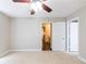 Bedroom featuring neutral walls, ceiling fan, and a doorway with views of an adjacent room at 1207 Mcclelen Way, Decatur, GA 30033