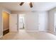 Carpeted bedroom includes ensuite bathroom and ceiling fan at 1207 Mcclelen Way, Decatur, GA 30033