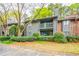 Exterior view of condo features a balcony and well-maintained landscaping at 1207 Mcclelen Way, Decatur, GA 30033