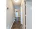 Hallway with wood-look floors and neutral walls with doorways leading to various rooms at 1207 Mcclelen Way, Decatur, GA 30033