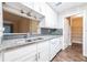 Updated kitchen features granite counters, stylish backsplash, and modern white cabinets at 1207 Mcclelen Way, Decatur, GA 30033