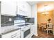 Well-equipped kitchen features modern appliances and a view into the dining area at 1207 Mcclelen Way, Decatur, GA 30033