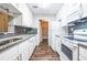 Updated kitchen with white cabinets, granite countertops, gray backsplash, and stainless-steel appliances at 1207 Mcclelen Way, Decatur, GA 30033