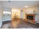 An open concept living room with a fireplace, dining area, and luxury vinyl plank flooring at 1207 Mcclelen Way, Decatur, GA 30033