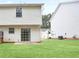 Exterior of house showing backyard with sliding glass doors and a lawn at 3116 Fields Dr, Lithonia, GA 30038