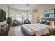 Bright bedroom features a large window, seating area, modern decor, and comfortable queen-size bed at 3116 Fields Dr, Lithonia, GA 30038