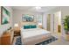 Well-lit bedroom with a bed dressed in blue and white, alongside matching nightstands and closet access at 3116 Fields Dr, Lithonia, GA 30038