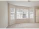 Bright bedroom featuring neutral walls, carpet, and a large bay window at 3116 Fields Dr, Lithonia, GA 30038