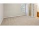 Spacious bedroom with neutral carpeting, a window for natural light, and access to a closet and bathroom at 3116 Fields Dr, Lithonia, GA 30038