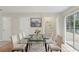 Bright dining area featuring a glass table, modern decor, and access to a pantry and outdoor space at 3116 Fields Dr, Lithonia, GA 30038