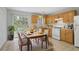 Eat-in kitchen features warm cabinets, white appliances, and a sliding glass door that offers easy access to the outdoor area at 3116 Fields Dr, Lithonia, GA 30038